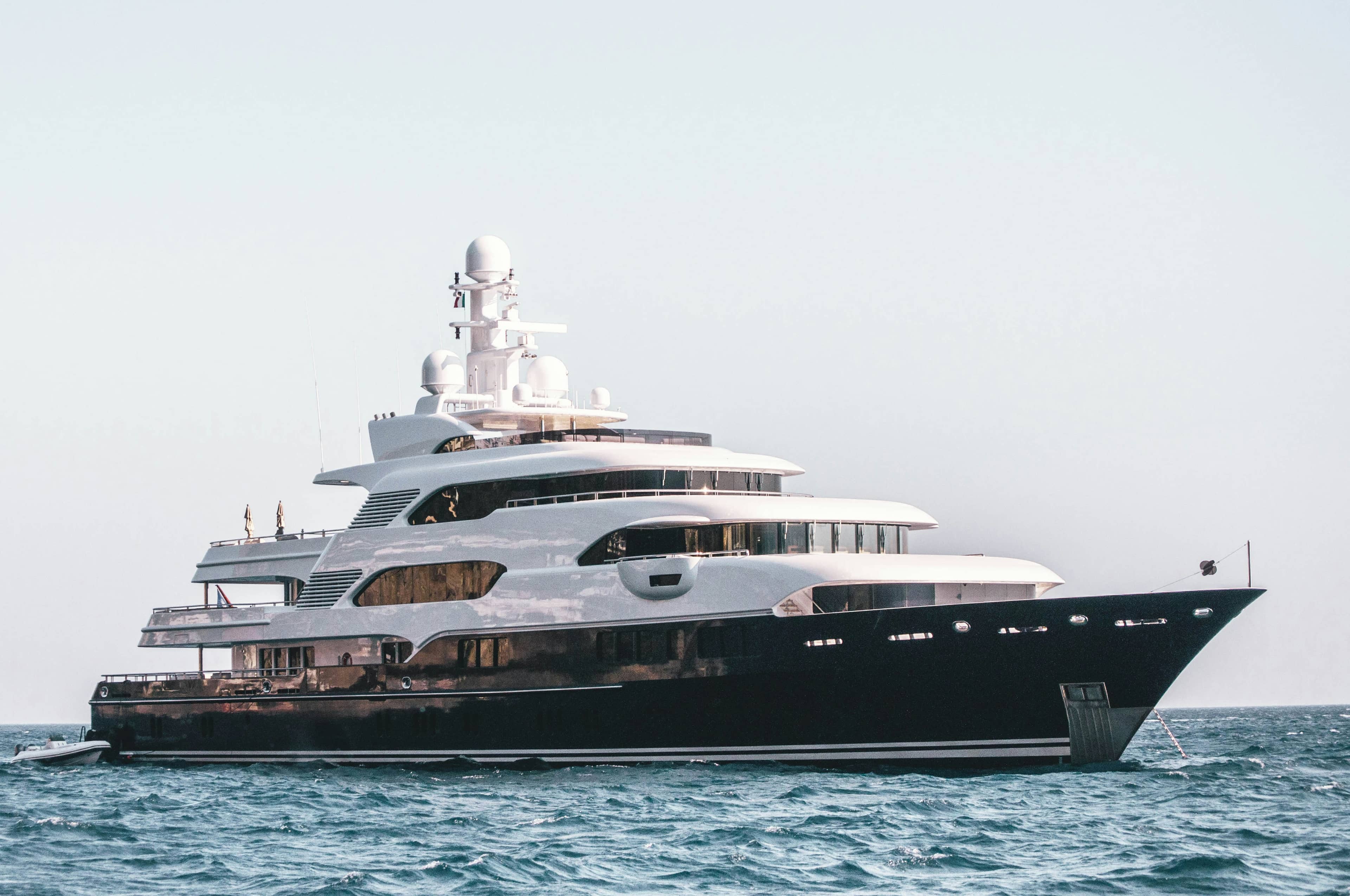 White luxury yacht cruising on calm blue waters