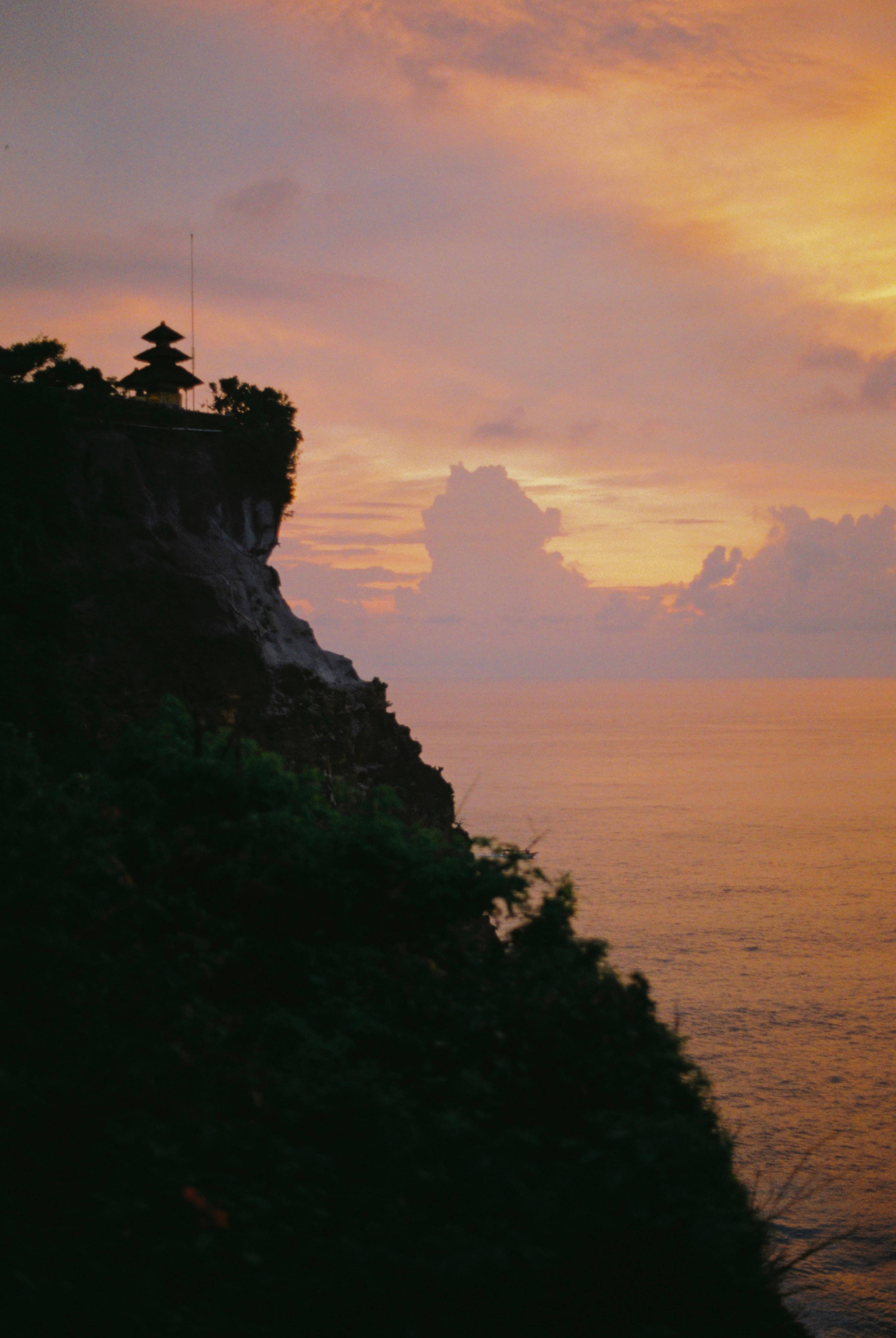 Sunset silhouette of Uluwatu Temple on its clifftop, Pecatu, Badung Regency, Bali