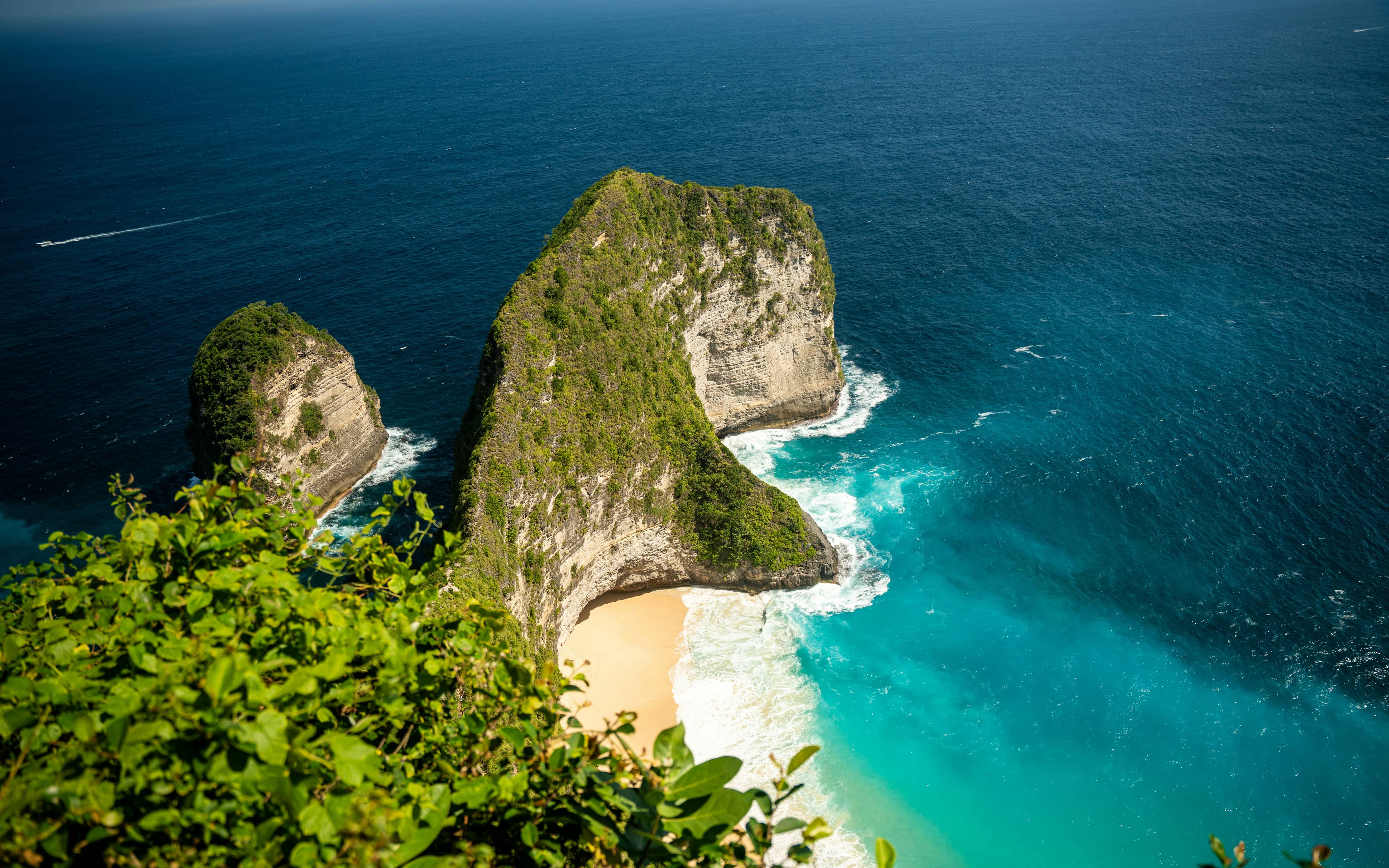 Dramatic cliffs overlooking a tropical beach with turquoise water, Bali coastline