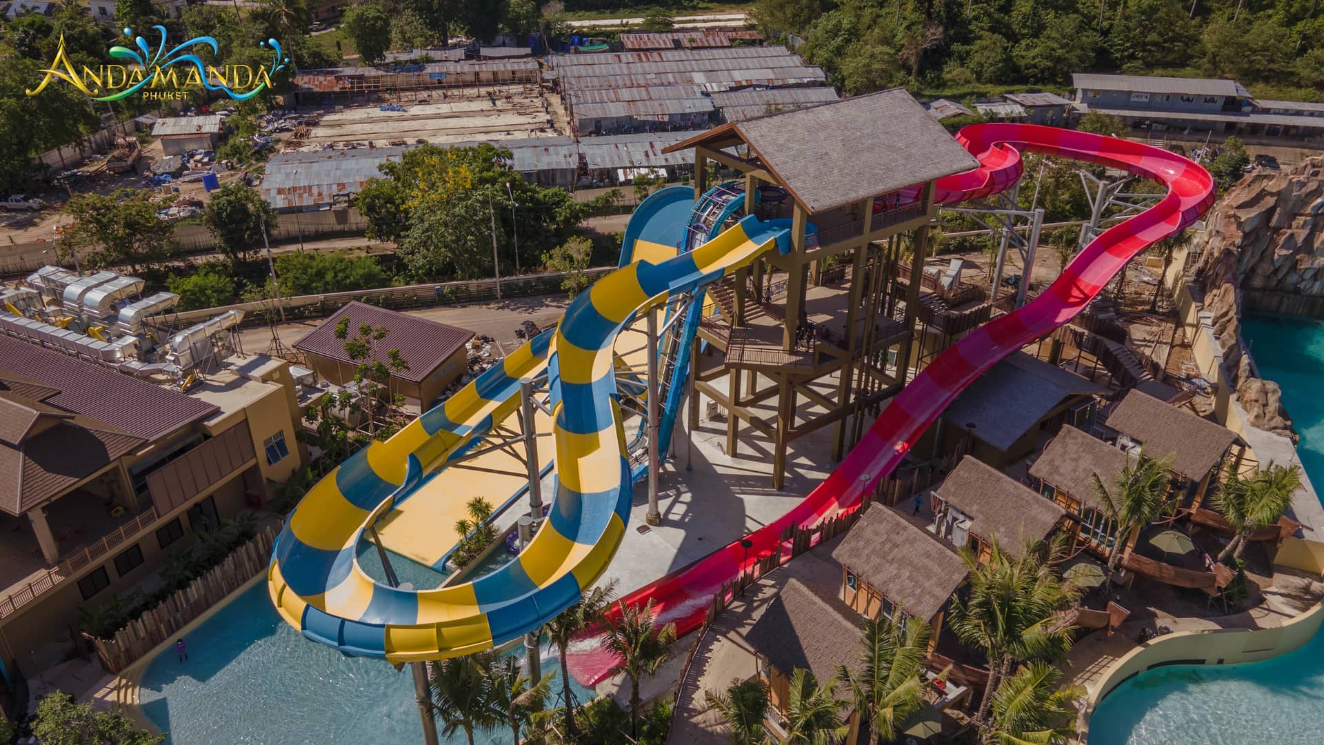 Aerial view of Andamanda Phuket water park Aerial view of Andamanda Phuket water park with colorful slides, pools and thatched-roof structures